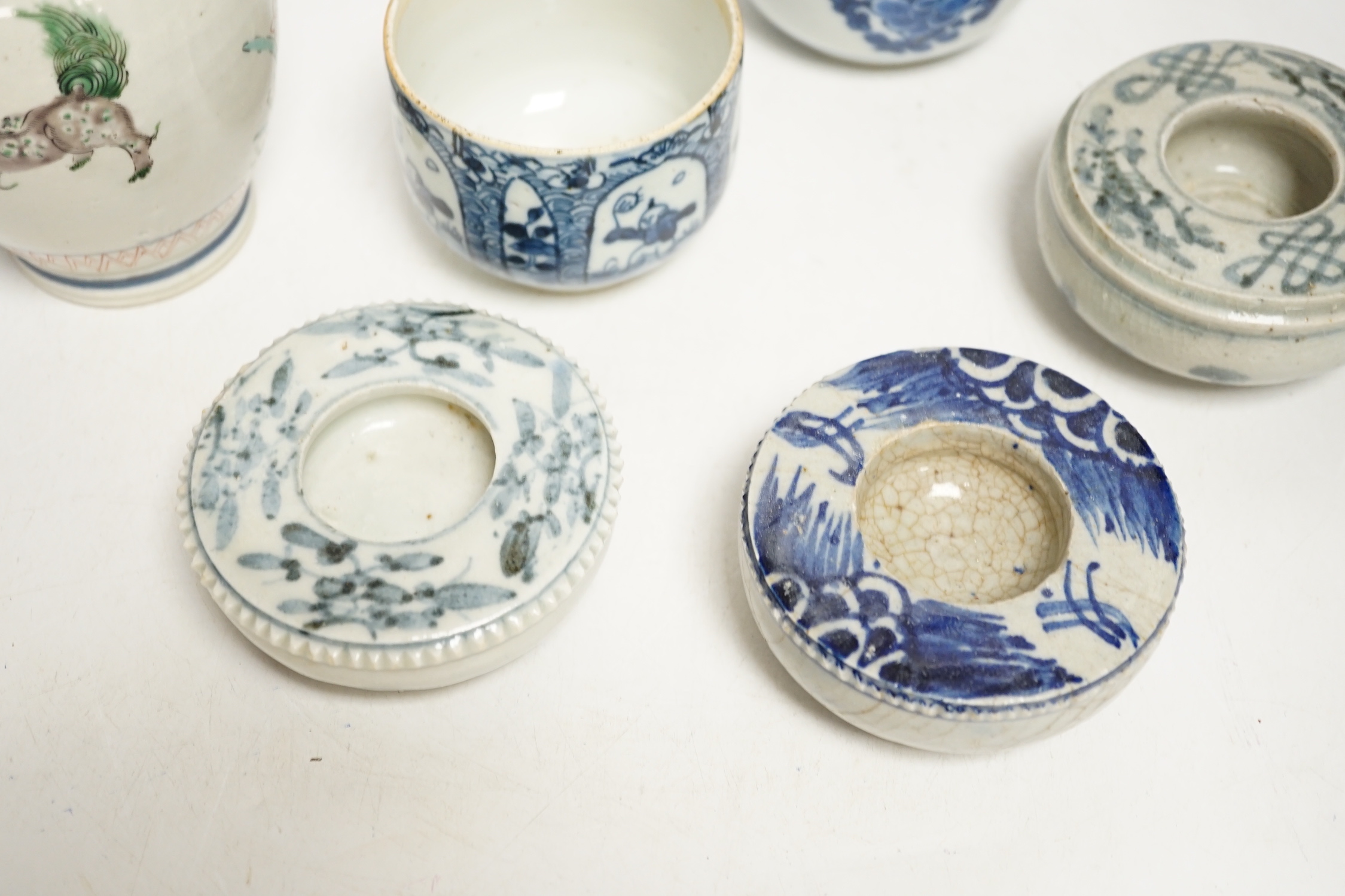 A group of Chinese ceramics, 17th/18th century, to include a famille verte mug (lacking handle) two U shaped bowls and three blue and white brush washers, largest 14cm high (a.f.)